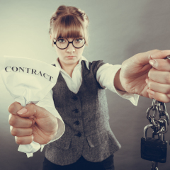 A businesswoman returning her contractual chains.